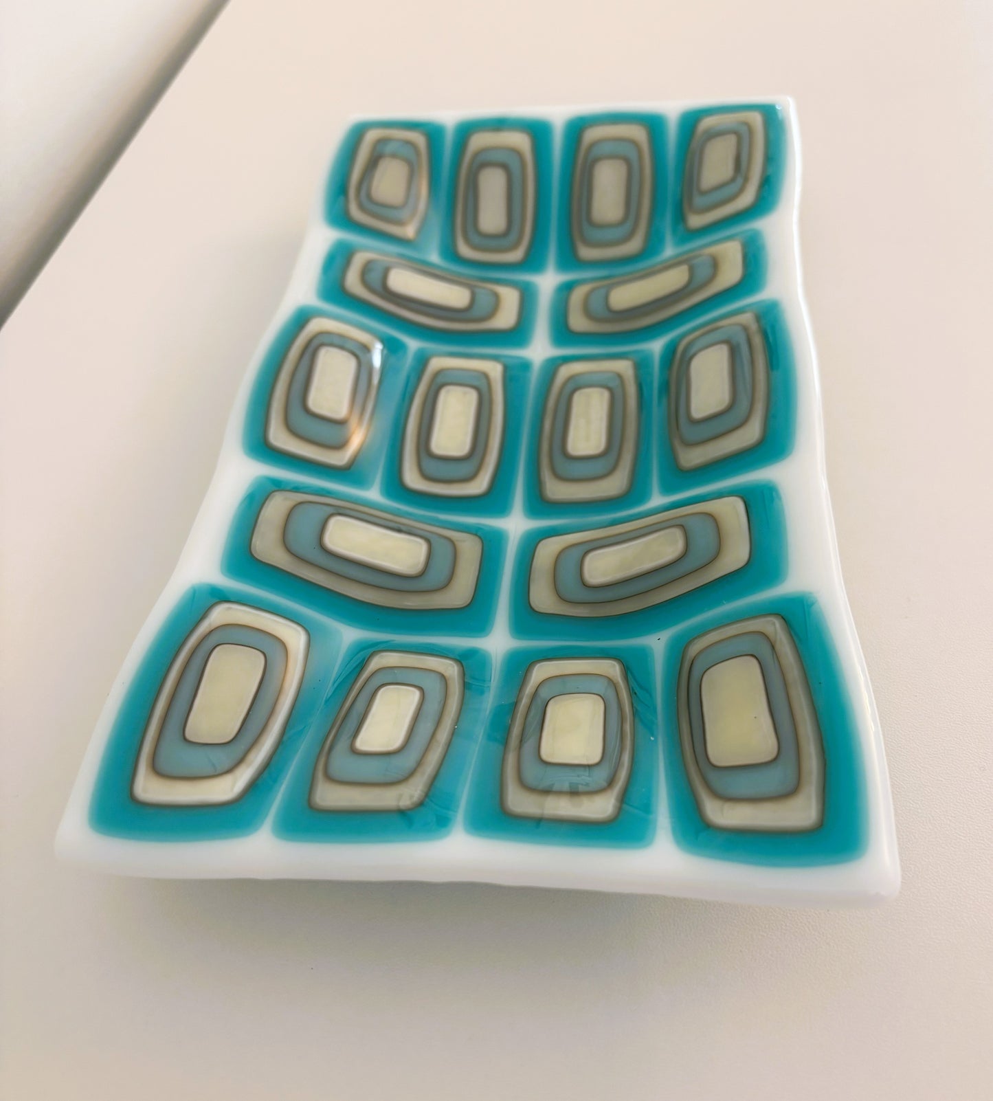 Layered turquoise, grey, vanilla on white